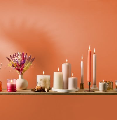 burning-candles-on-orange-background