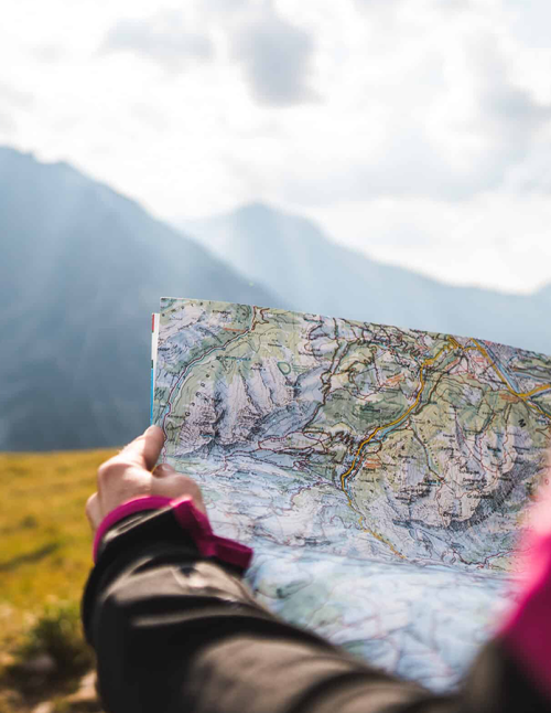 adventurous person navigating topographic map