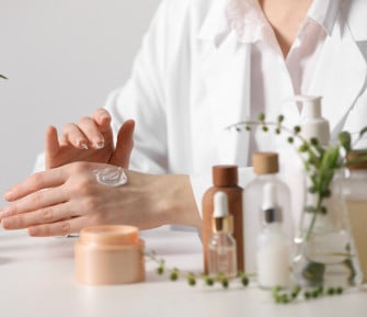 dermatologist applying cream onto hand