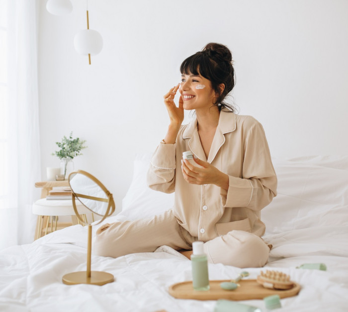 happy woman doing routine skin care