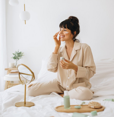 happy woman doing routine skin care