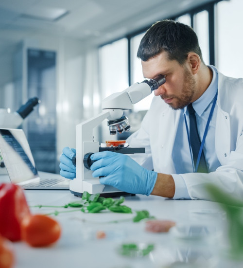 male scientist safety glasses analysing