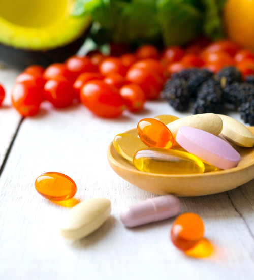 pills capsules wooden spoon fresh fruits