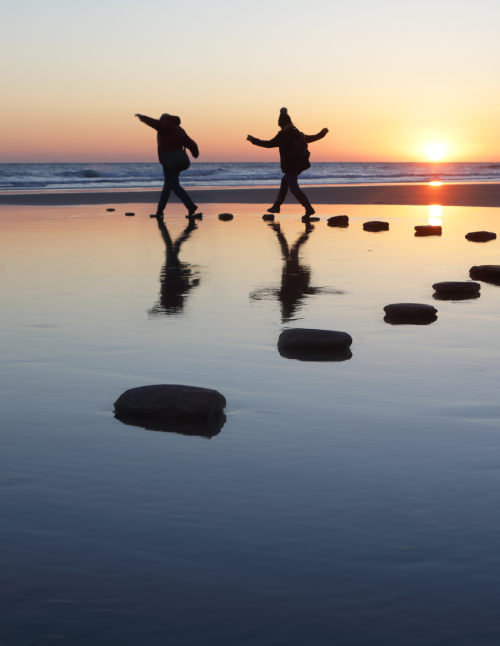 people rocks sea