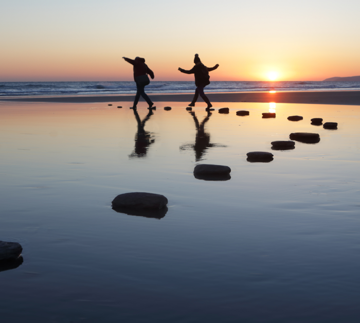 people rocks sea