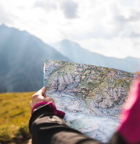 adventurous person navigating topographic map