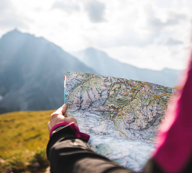 adventurous person navigating topographic map