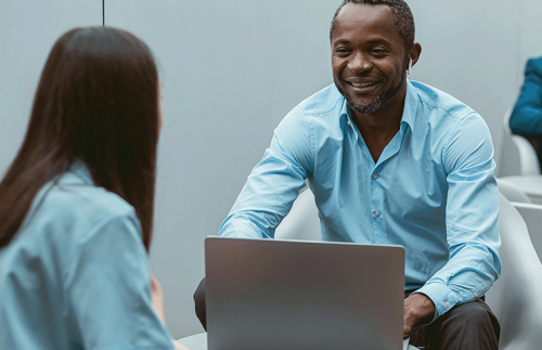 generic man looking at woman laptop SL3