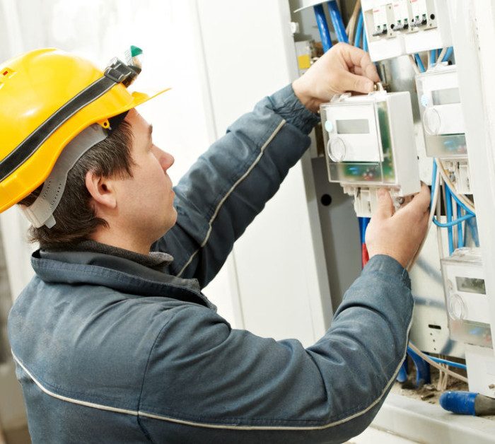 Electrician installing energy saving meter