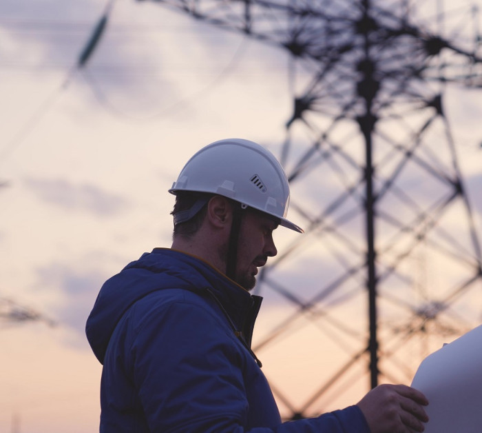 electrician on background high towers power