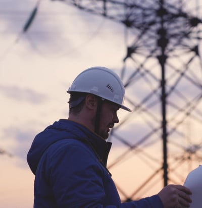electrician on background high towers power