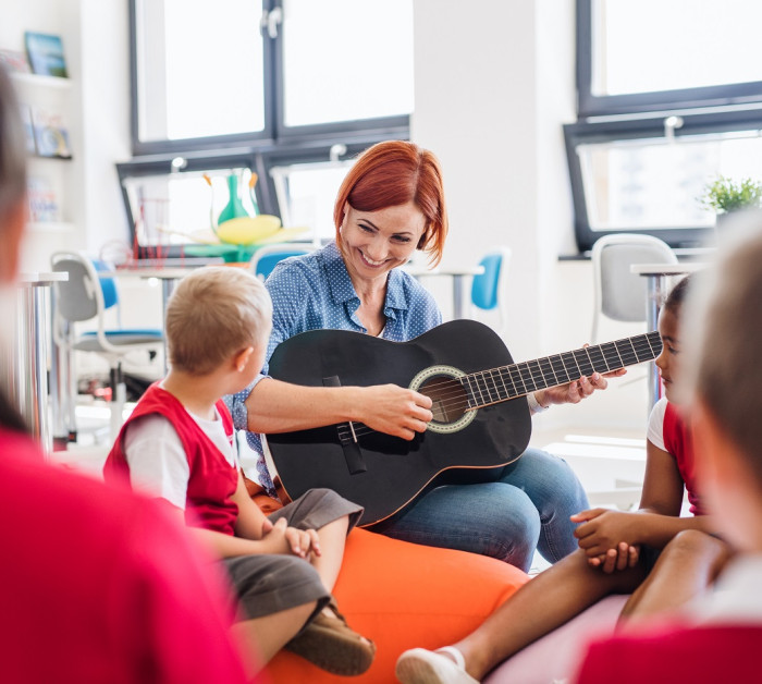 group small school kids teacher guitar