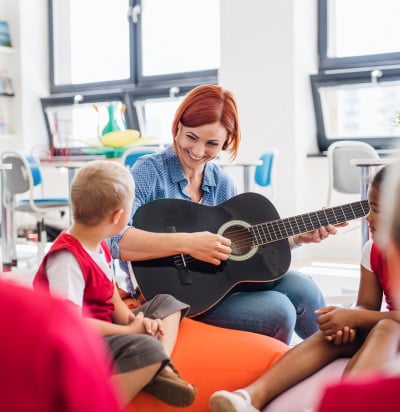 group small school kids teacher guitar