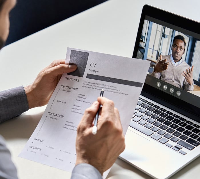male hr recruiter employer holding cv