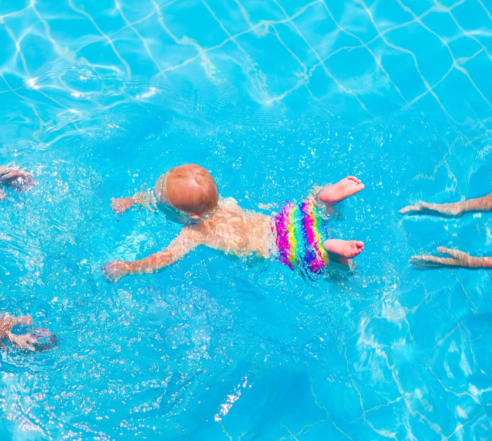 cute little baby swimming underwater mother