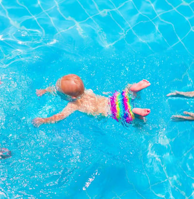 cute little baby swimming underwater mother