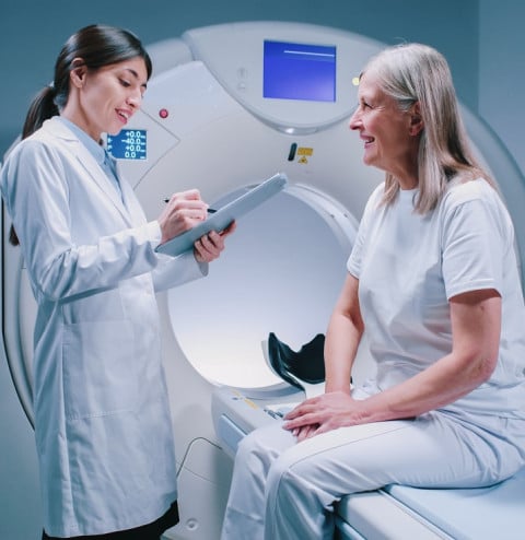 female doctor standing near patience machine