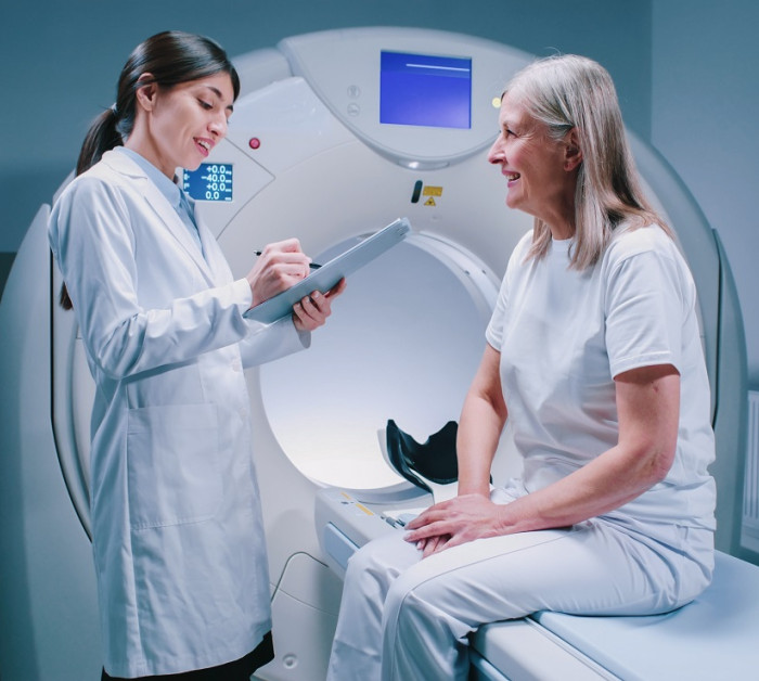 female doctor standing near patience machine
