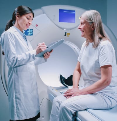 female doctor standing near patience machine