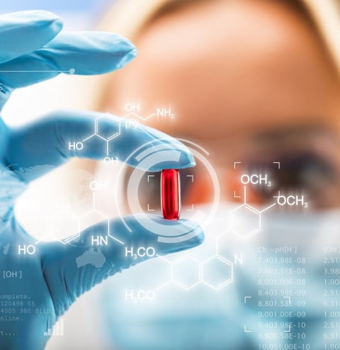 female scientist holding red pill