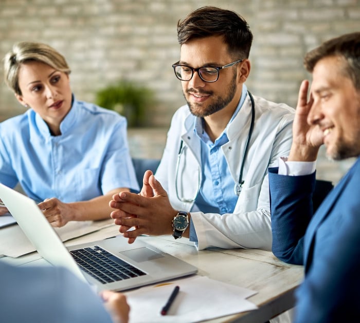 group healthcare workers businessman using laptop