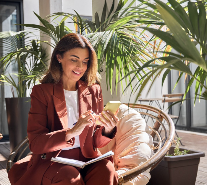 Business woman phone orange suit