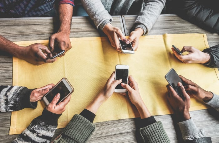 diverse group young people using smart phone