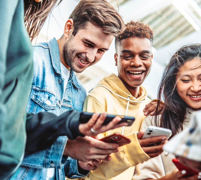 diverse group young people using smart phone