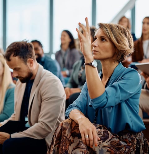 female entrepreneur raising her hand answer
