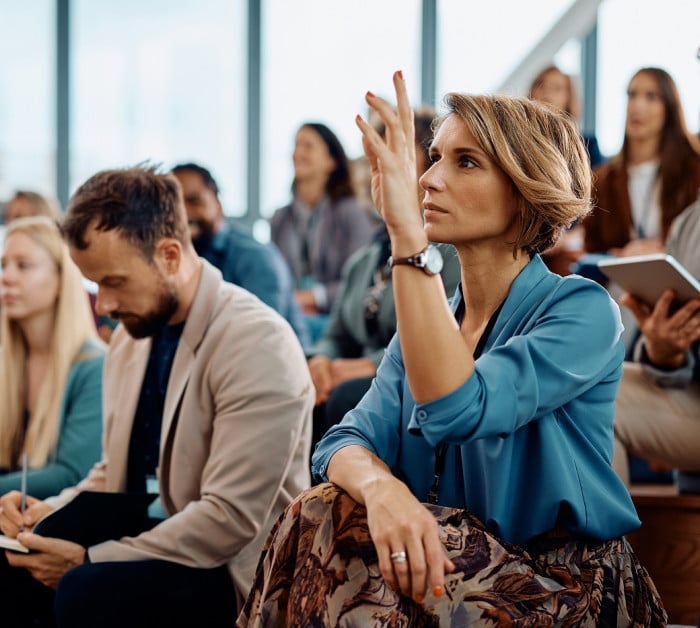 female entrepreneur raising her hand answer
