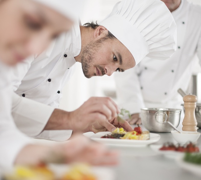 team preparing dishes professional kitchen