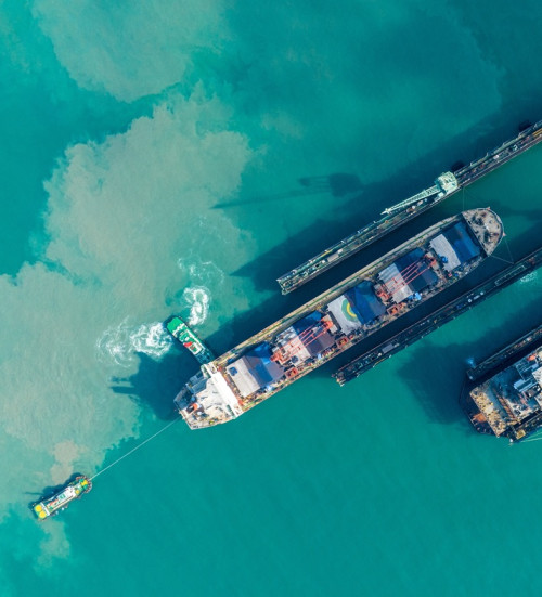 tug boat draging cargo container ship