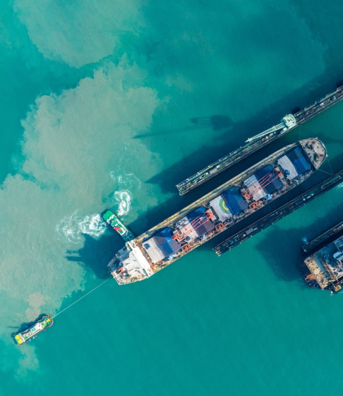 tug boat draging cargo container ship