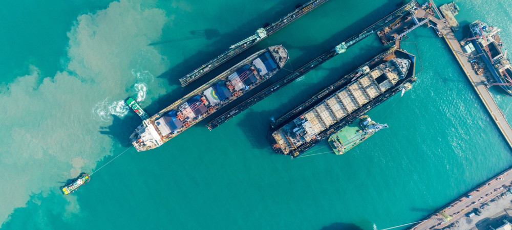 tug boat draging cargo container ship