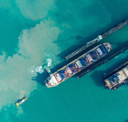tug boat draging cargo container ship