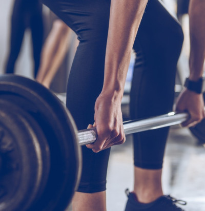 close partial view sportswoman lifting barbell