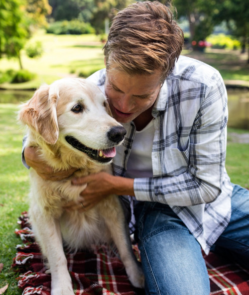 man embracing his dog