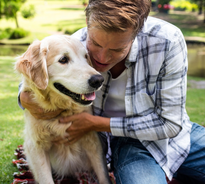 man embracing his dog