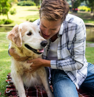 man embracing his dog