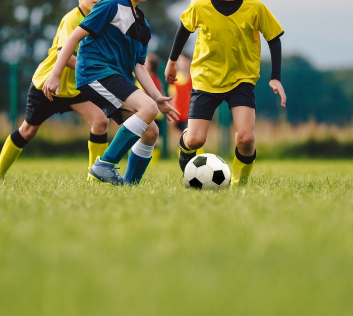 young boys playing soccer game kids