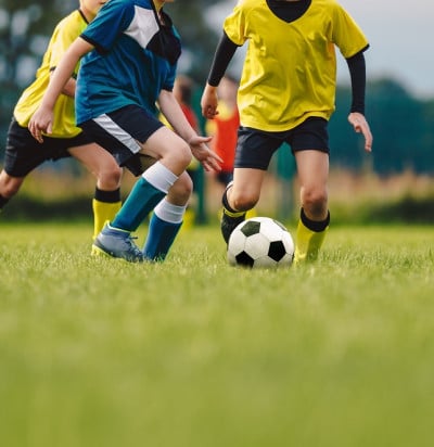 young boys playing soccer game kids