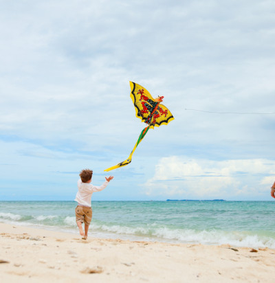 young father his son running kite