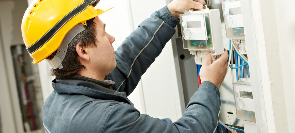Electrician installing energy saving meter