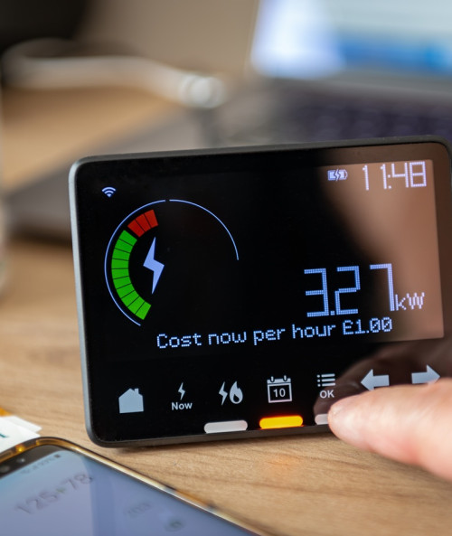 person checking calculating energy cost on meter