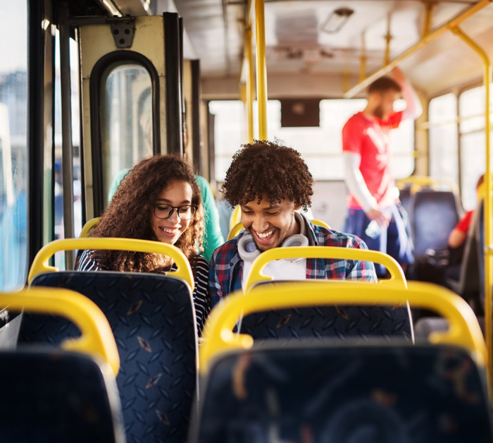 young happy couple sitting together on bus