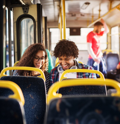 young happy couple sitting together on bus