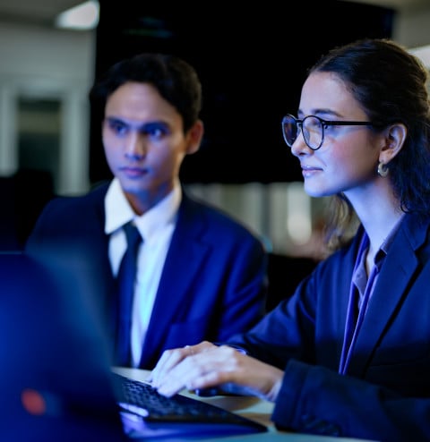 Two people looking at computer screen