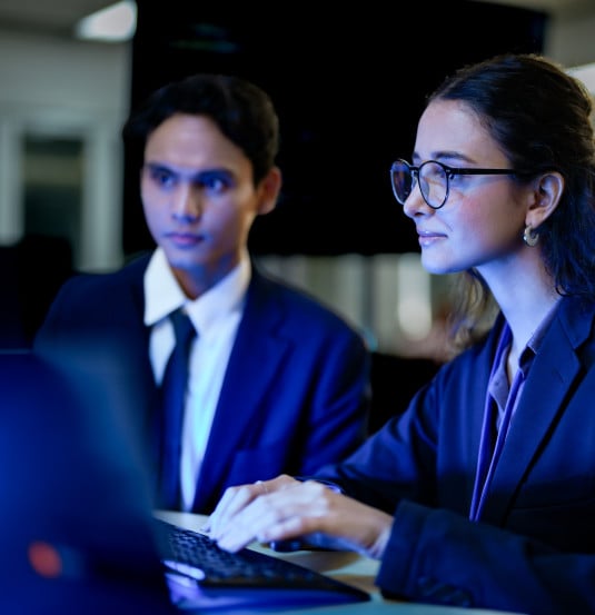 Two people looking at computer screen