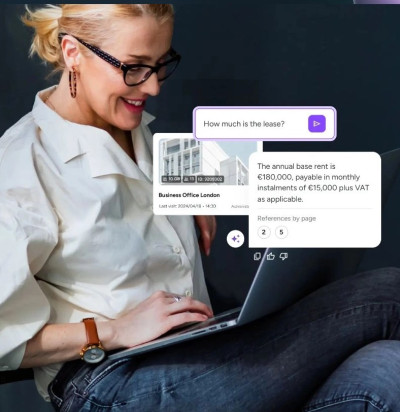 smiling woman working on laptop with real estate chat interface